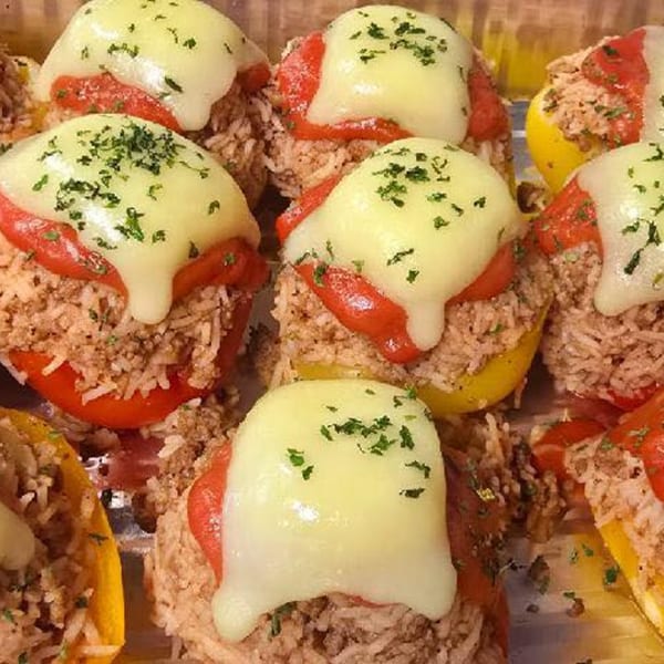 Close-up of Only Pans' stuffed bell peppers with melted cheese and herbs.